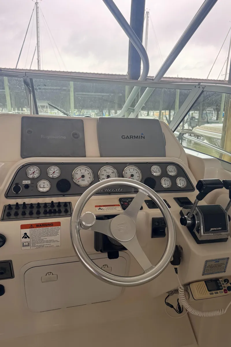 Slide: The Image of 2004 Wellcraft 290 Coastal helm with Garmin navigation and control panel. - 20