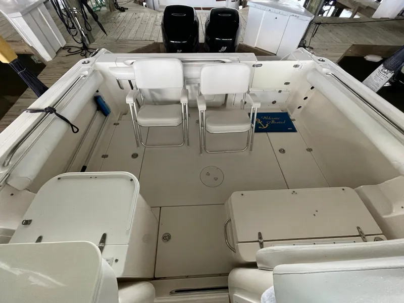 Slide: The Image of 2004 Wellcraft 290 Coastal boat interior with seating and storage compartments. - 24