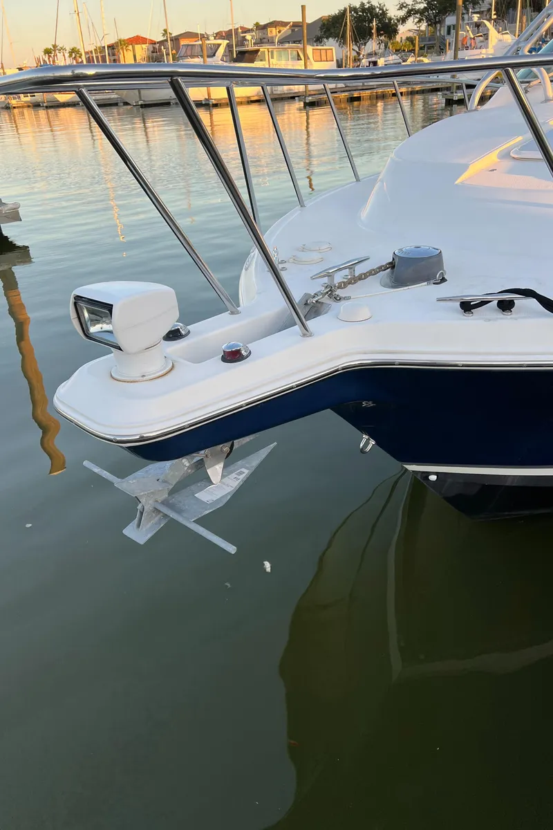 Slide: The Image of 2004 Wellcraft 290 Coastal boat docked in a marina at sunset. - 27