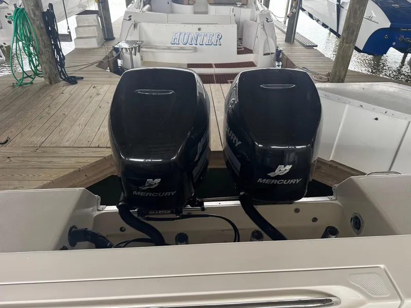 Slide: The Image of Twin Mercury outboard engines on a 2004 Wellcraft 290 Coastal boat at a dock. - 39