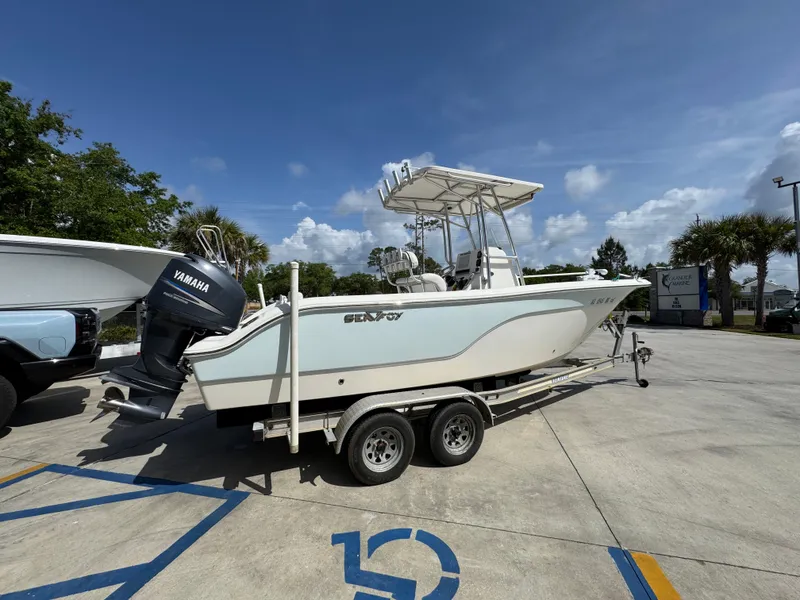 Slide: The Image of 2011 Sea Fox 236 Center Console boat on trailer, parked outdoors under clear sky. - 13