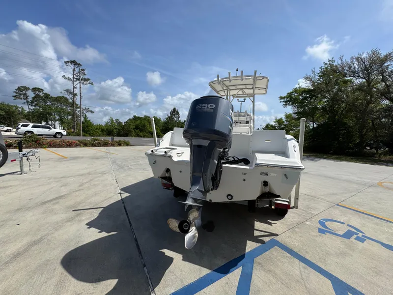 Slide: The Image of 2011 Sea Fox 236 Center Console boat with outboard motor in a parking lot. - 16