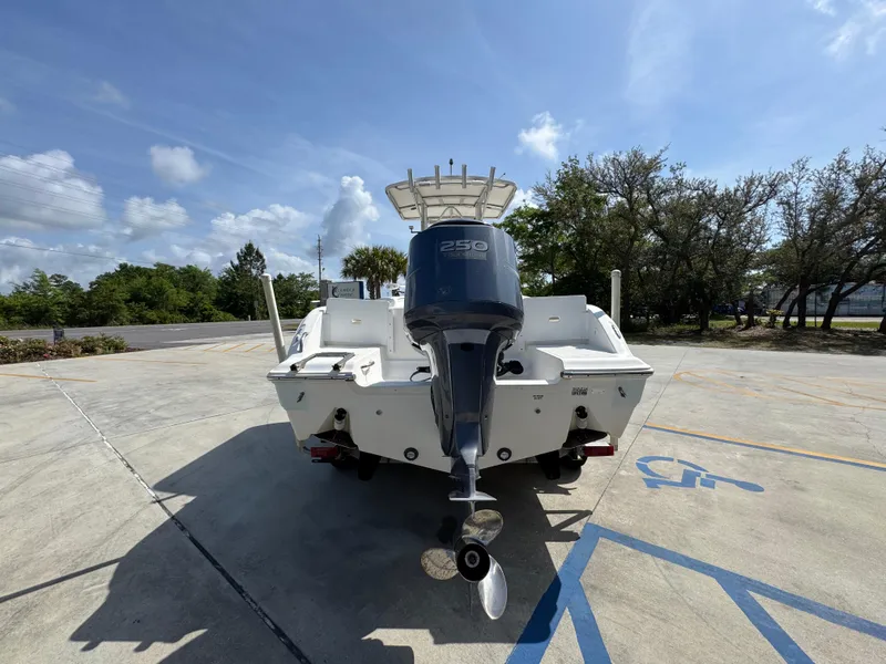 Slide: The Image of 2011 Sea Fox 236 Center Console boat with outboard motor in a parking lot. - 17