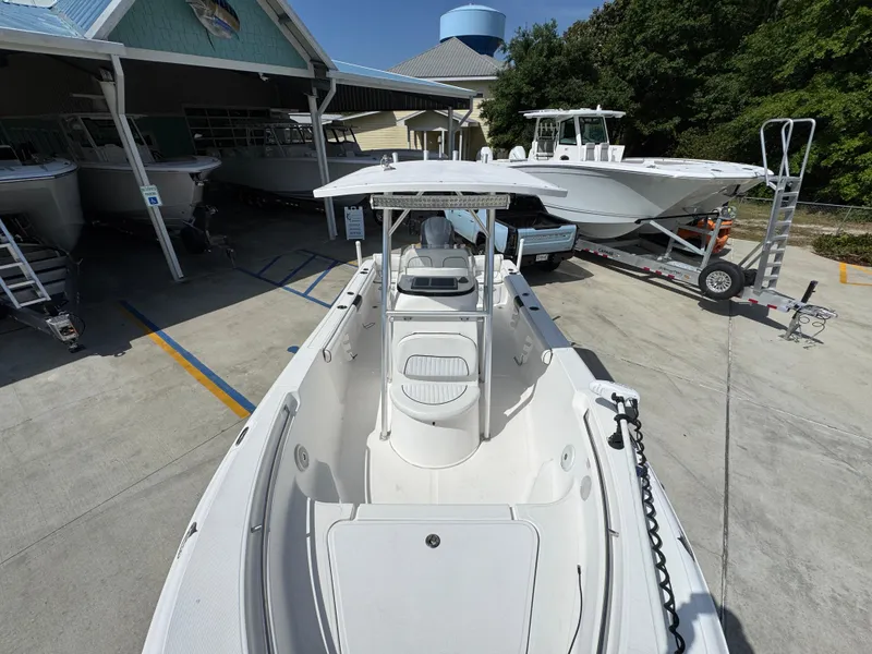 Slide: The Image of 2011 Sea Fox 236 Center Console boat in a marina, showcasing spacious deck and console. - 25