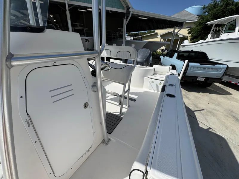 Slide: The Image of 2011 Sea Fox 236 Center Console boat, docked with visible seating and storage compartments. - 28