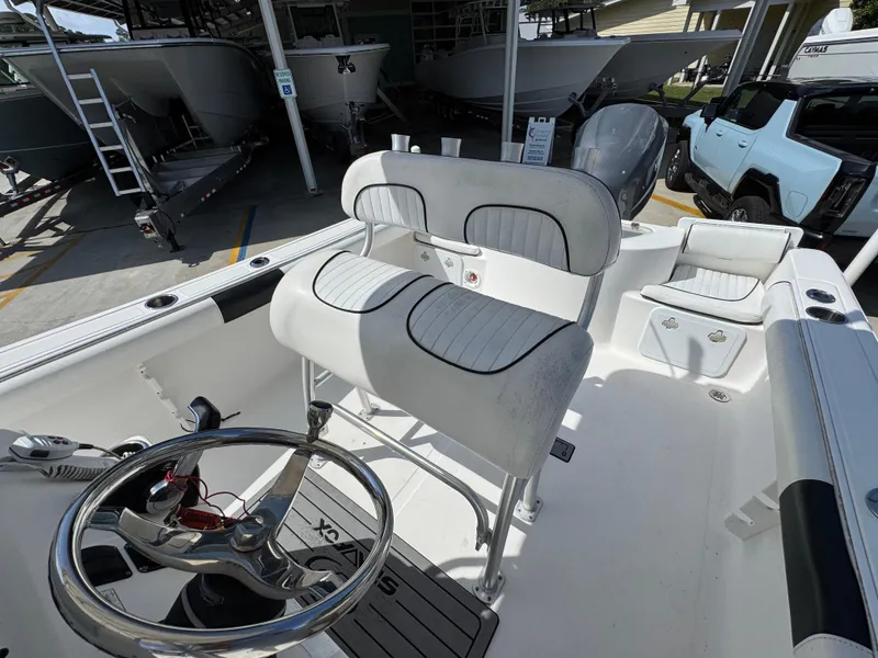 Slide: The Image of 2011 Sea Fox 236 Center Console boat interior with steering wheel and seating. - 30