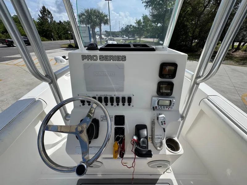 Slide: The Image of 2011 Sea Fox 236 Center Console boat dashboard with steering wheel and controls. - 33