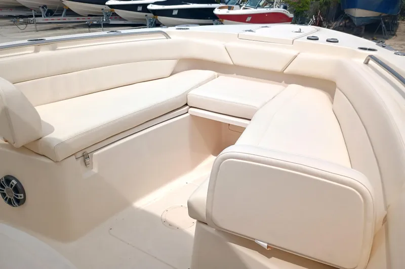 Slide: The Image of 2025 Grady-White Canyon 271 boat interior with beige seating and spacious layout. - 25
