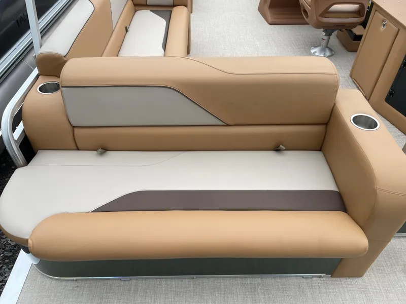 Slide: The Image of 2025 Tahoe Pontoon 2185 CRB interior with tan seating and modern steering console. - 11