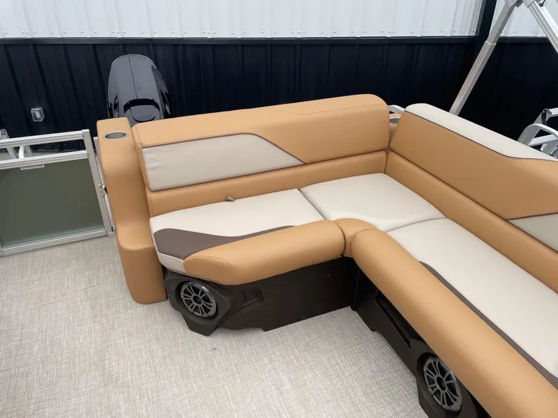 Slide: The Image of 2025 Tahoe Pontoon 2185 CRB with tan and cream seating, featuring built-in speakers. - 12