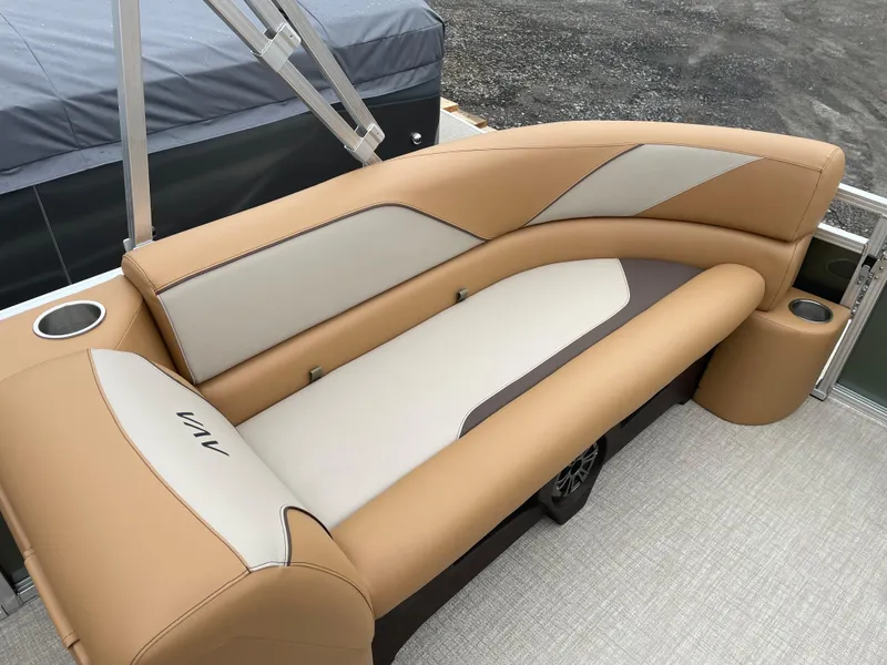 Slide: The Image of 2025 Tahoe Pontoon 2185 CRB boat interior with tan and cream seating. - 13