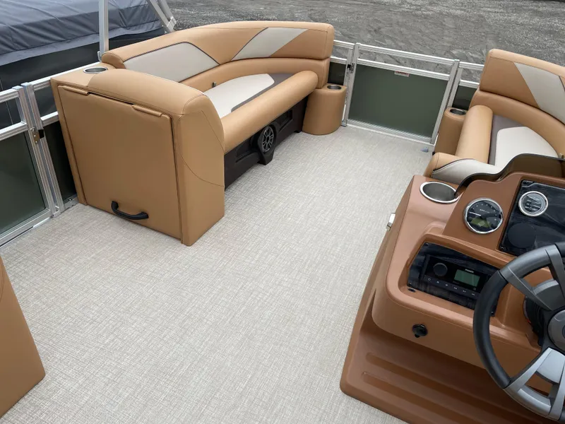 Slide: The Image of 2025 Tahoe Pontoon 2185 CRB with tan seating, docked outdoors. - 8