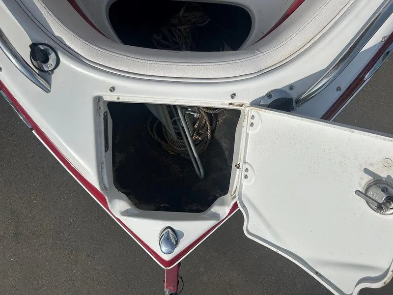 Slide: The Image of Open storage compartment on 2013 Crownline 21 SS boat, showing anchor and ropes. - 11