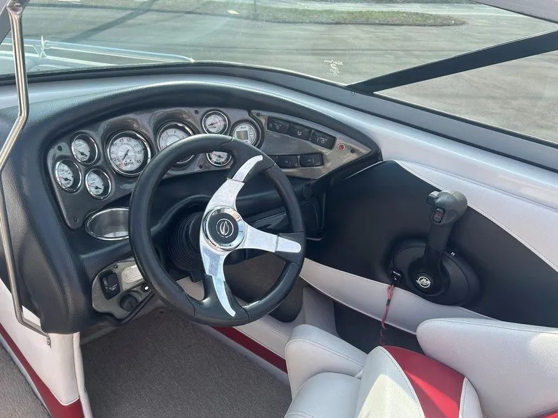 Slide: The Image of Interior view of 2013 Crownline 21 SS boat dashboard with steering wheel and gauges. - 16