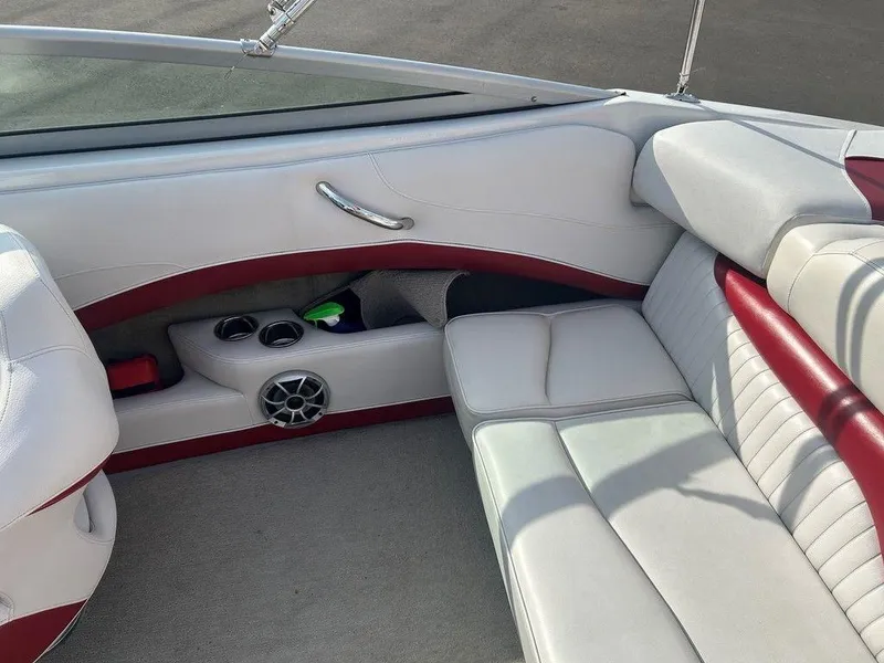 Slide: The Image of 2013 Crownline 21 SS boat interior with white and red seating, cup holders, and speaker. - 19