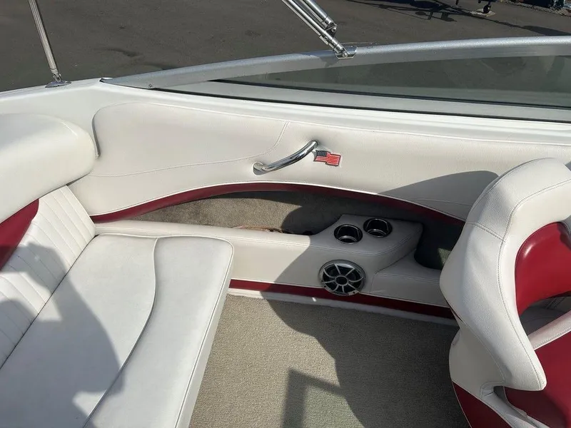 Slide: The Image of 2013 Crownline 21 SS boat interior with white and red seating, cup holders, and speaker. - 20