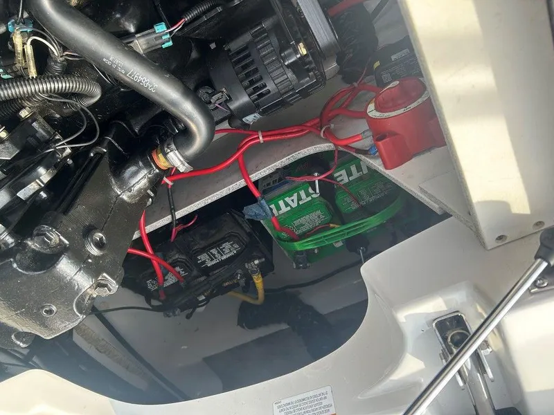 Slide: The Image of Engine compartment of a 2013 Crownline 21 SS boat, showing wiring and components. - 27