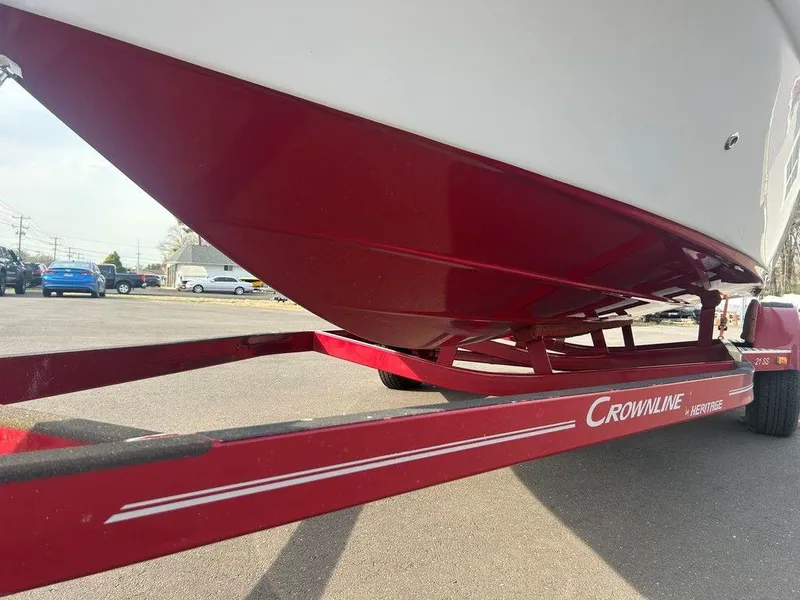 Slide: The Image of 2013 Crownline 21 SS boat on red trailer, parked outdoors. - 30