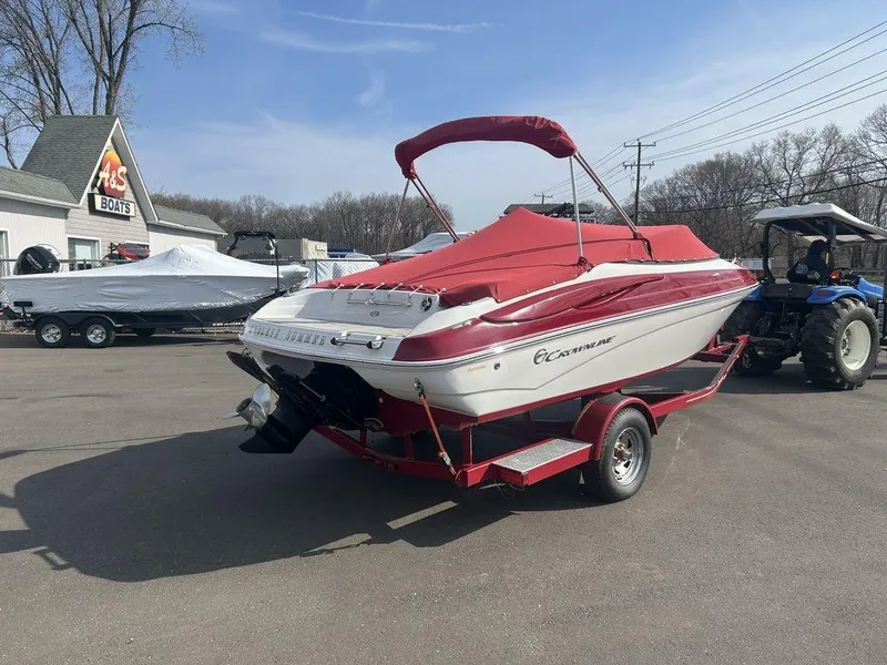 Slide: The Image of 2013 Crownline 21 SS boat on trailer with red cover in outdoor setting. - 4