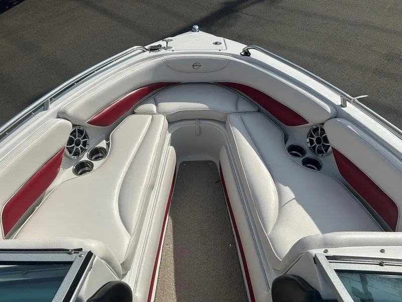 Slide: The Image of 2013 Crownline 21 SS boat interior with white and red seating, cup holders, and speakers. - 7