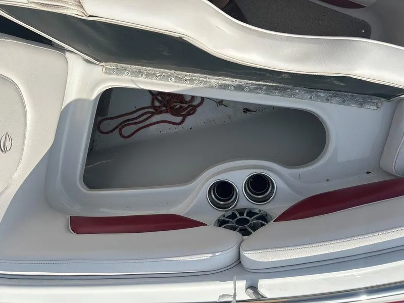 Slide: The Image of 2013 Crownline 21 SS boat interior storage compartment with red rope and speaker system. - 8