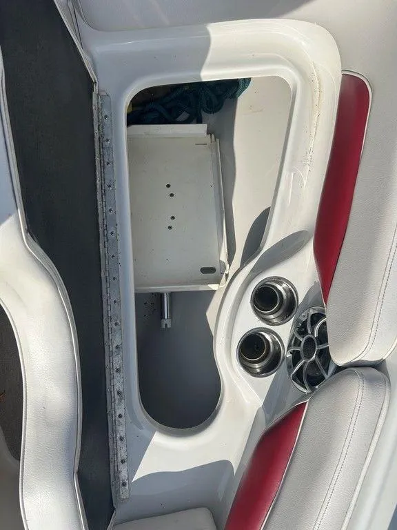 Slide: The Image of Crownline 21 SS 2013 boat interior with storage compartment and cup holders. - 9