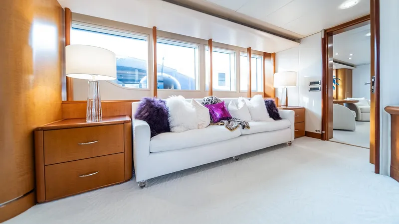 Slide: The Image of Luxurious yacht interior with white sofa, plush pillows, and elegant wooden furnishings on Feadship TASIA. - 11