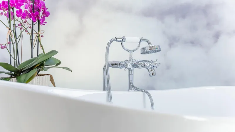 Slide: The Image of Luxurious bathtub with chrome fixtures and vibrant orchids, Feadship TASIA 1997. - 14