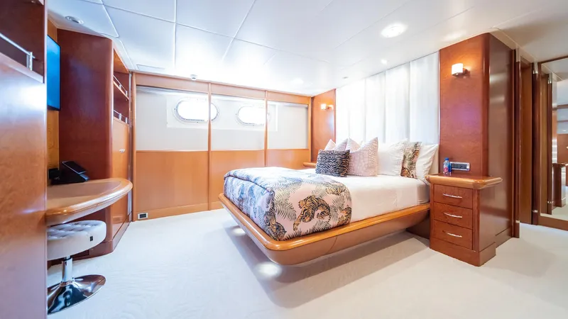 Slide: The Image of Luxurious bedroom interior on 1997 Feadship TASIA yacht with elegant wood finishes. - 18