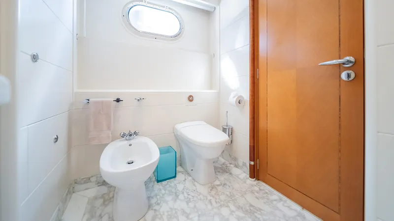 Slide: The Image of Luxurious yacht bathroom with marble floor, featuring a bidet and toilet, aboard Feadship TASIA, 1997. - 20