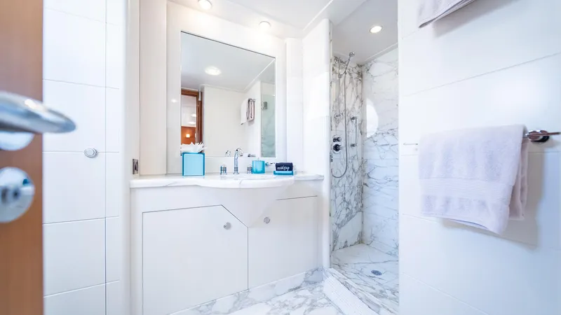 Slide: The Image of Luxurious yacht bathroom with marble shower, elegant vanity, and modern fixtures on Feadship TASIA. - 21