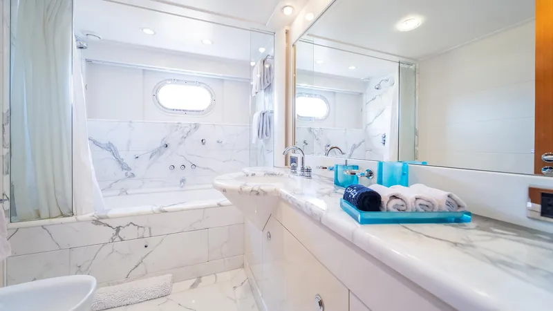 Slide: The Image of Luxurious marble bathroom on 1997 Feadship TASIA yacht, featuring elegant fixtures and amenities. - 22