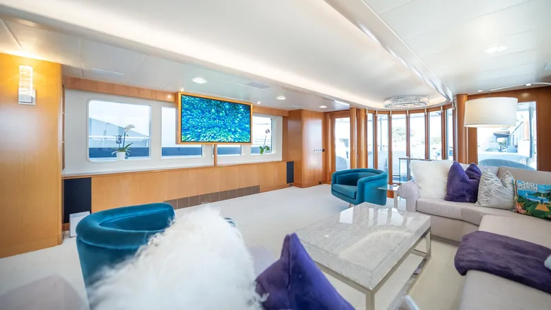 Slide: The Image of Luxurious interior of 1997 Feadship TASIA yacht with modern decor and plush seating. - 26