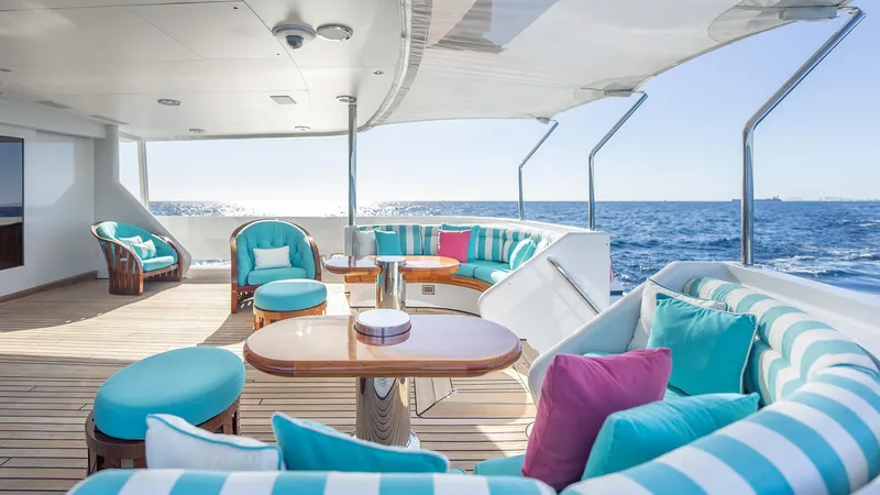 Slide: The Image of Luxurious Feadship TASIA yacht deck with colorful seating, ocean view, and elegant design, 1997 model. - 27