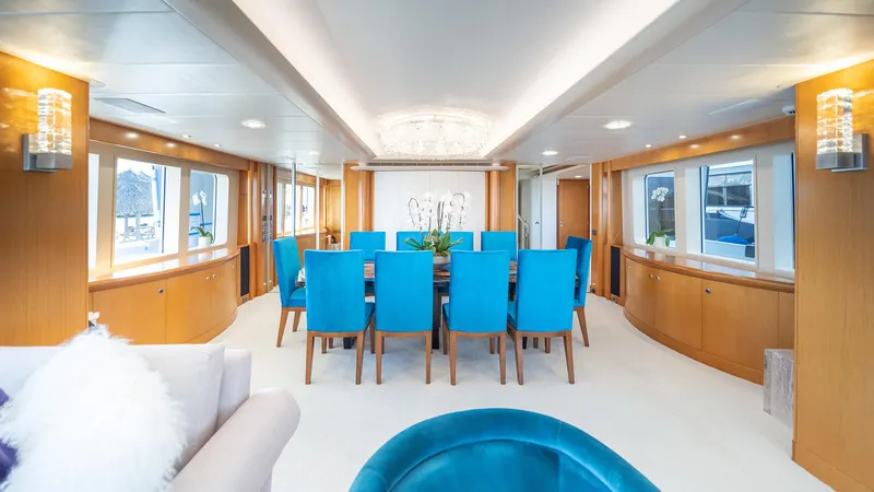 Slide: The Image of Luxurious dining area on 1997 Feadship TASIA yacht with blue chairs and elegant decor. - 28