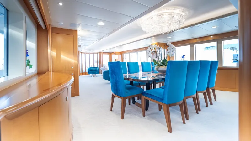 Slide: The Image of Luxurious dining area on 1997 Feadship TASIA yacht with blue chairs and elegant decor. - 3