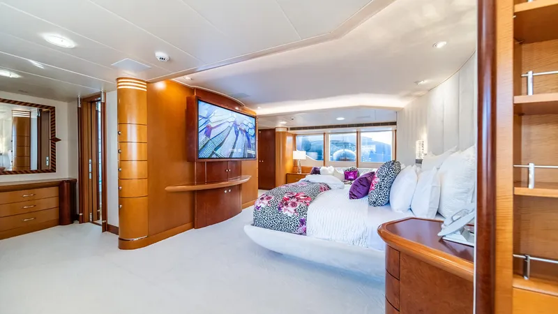 Slide: The Image of Luxurious bedroom interior on 1997 Feadship TASIA yacht, featuring elegant wood finishes and modern amenities. - 31