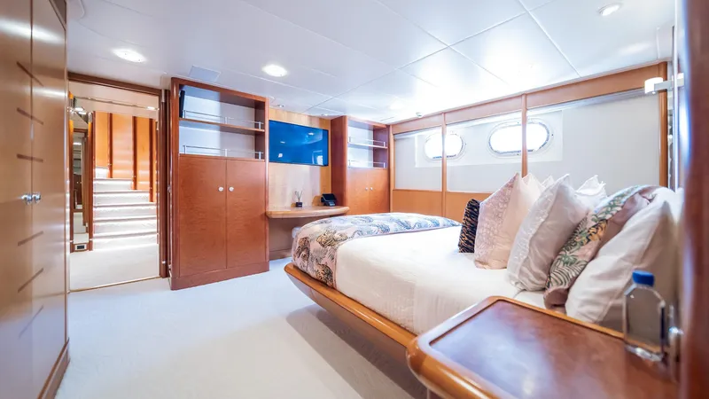 Slide: The Image of Luxurious bedroom interior on 1997 Feadship TASIA yacht with elegant wood finishes. - 34
