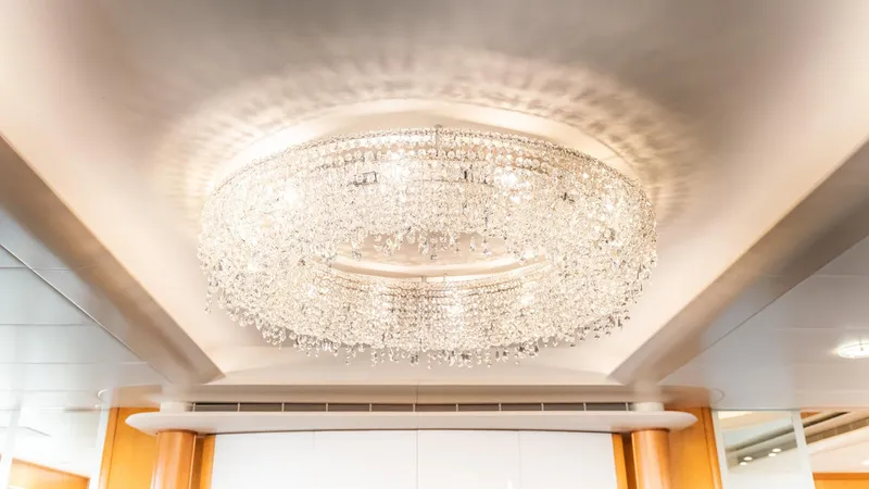 Slide: The Image of Luxurious crystal chandelier aboard 1997 Feadship TASIA yacht interior. - 4