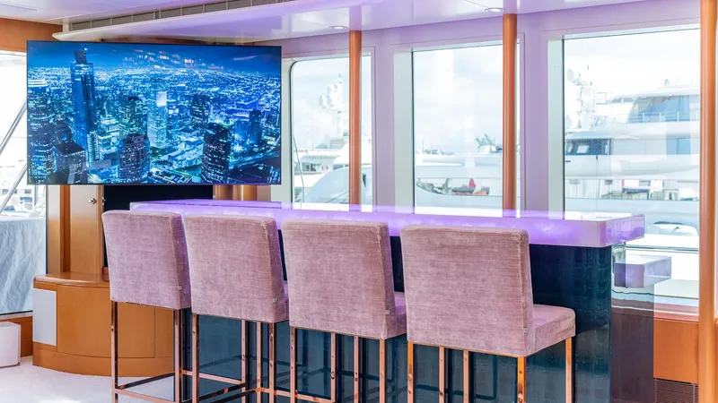 Slide: The Image of Luxurious yacht interior with bar seating and large screen, Feadship TASIA 1997 model. - 40