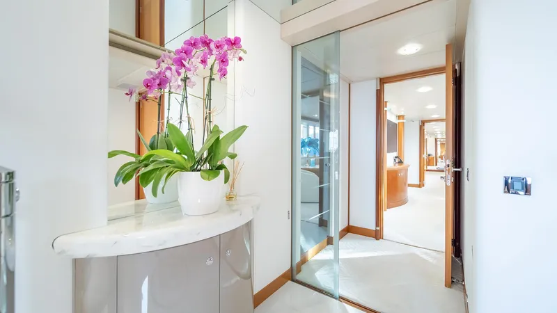 Slide: The Image of Luxurious interior of 1997 Feadship TASIA yacht with elegant decor and vibrant orchids. - 7