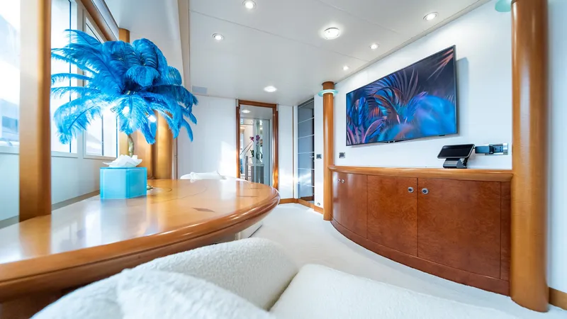 Slide: The Image of Luxurious interior of 1997 Feadship TASIA yacht with modern decor and vibrant artwork. - 9