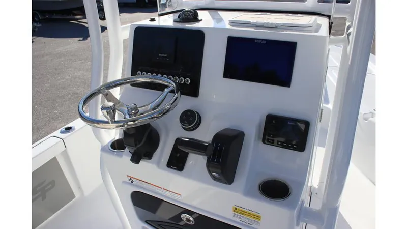 Slide: The Image of 2025 Sea Pro 230 Bay boat console with steering wheel and electronic controls. - 10