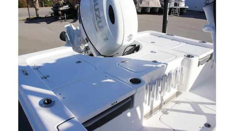 Slide: The Image of 2025 Sea Pro 230 Bay boat deck with Suzuki outboard motor, rod holders, and storage compartments. - 3