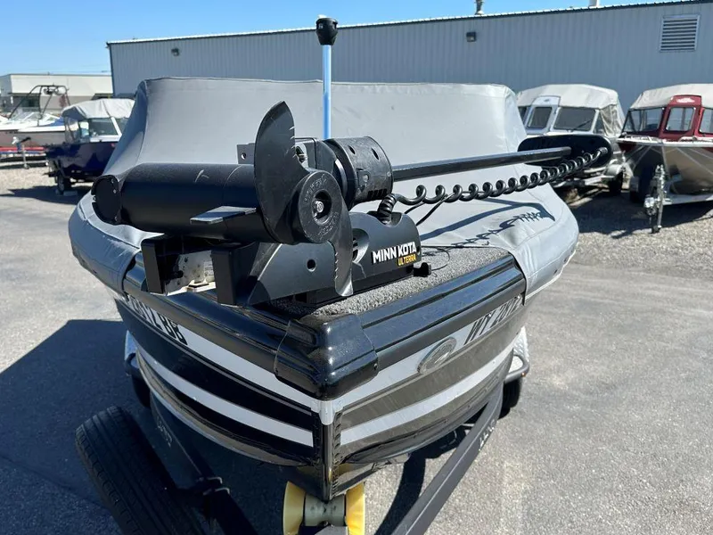 Slide: The Image of 2020 Lund 1875 Tyee boat with Minn Kota trolling motor, parked outdoors. - 3