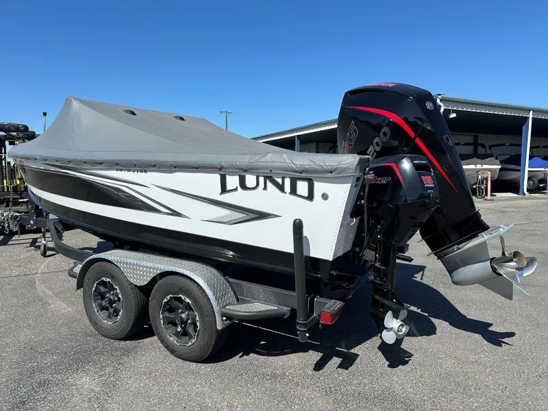 Slide: The Image of 2020 Lund 1875 Tyee boat with cover and outboard motor on a trailer. - 4