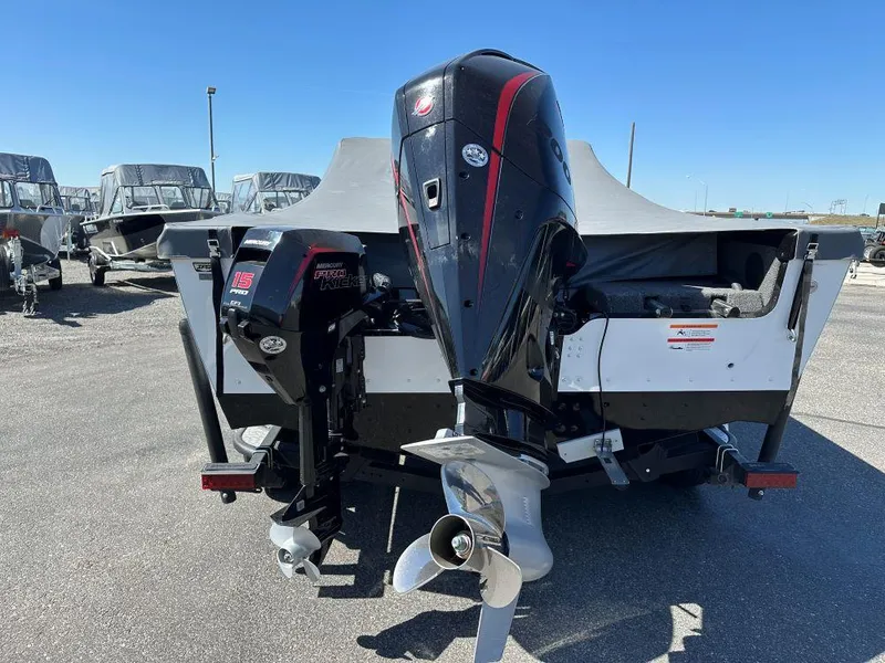 Slide: The Image of 2020 Lund 1875 Tyee boat with powerful outboard motor, parked outdoors. - 5