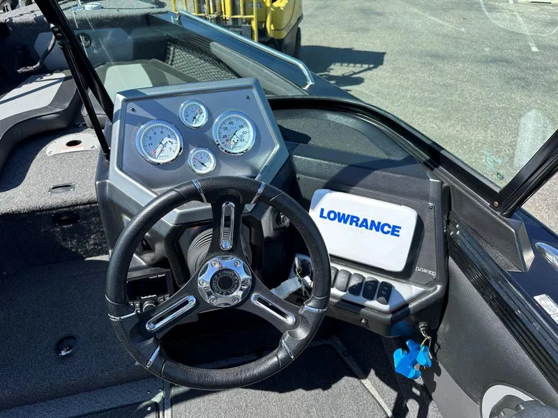 Slide: The Image of 2020 Lund 1875 Tyee boat dashboard with steering wheel and Lowrance navigation system. - 7