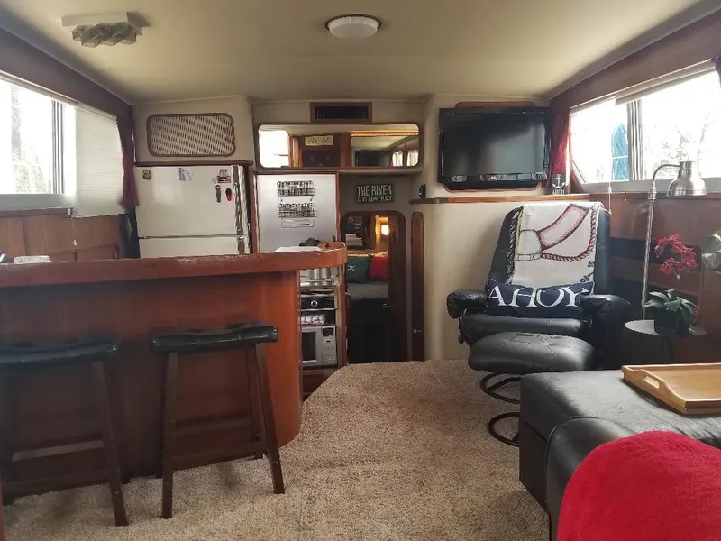 Slide: The Image of Interior of 1986 Chris-Craft Constellation yacht with cozy seating and modern amenities. - 3