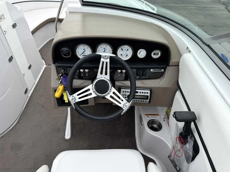 Slide: The Image of 2007 Four Winns 224 Funship boat dashboard with steering wheel and gauges. - 12